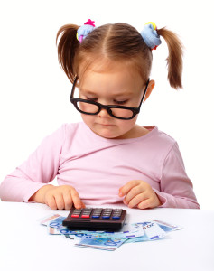 Cute little girl plays with money, isolated over white